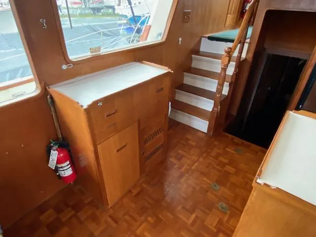Slide: The Image of Interior of 1980 Ocean Alexander 50 MK1 yacht with wooden flooring and staircase. - 9