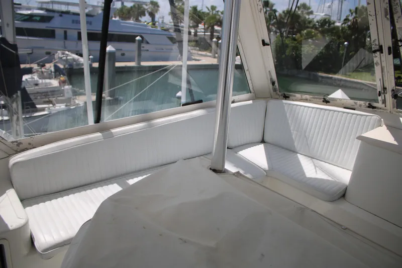 Slide: The Image of 1999 Ocean Yachts interior with white seating, docked at marina. - 22