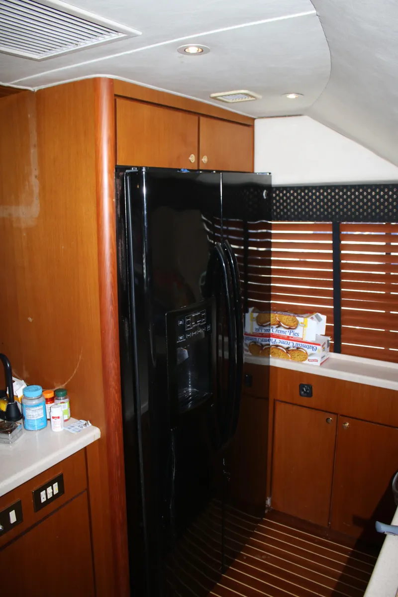 Slide: The Image of Interior of a 1999 Ocean Yachts model, featuring a sleek kitchen area. - 3