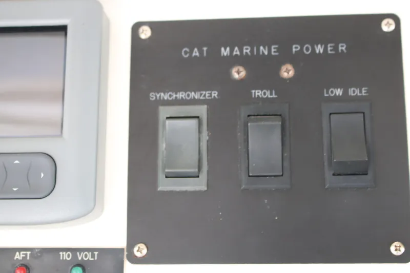 Slide: The Image of Control panel of a 1999 Ocean Yachts featuring CAT Marine Power switches. - 38