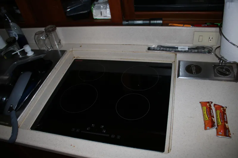Slide: The Image of 1999 Ocean Yachts kitchen with electric stove and countertop accessories. - 42
