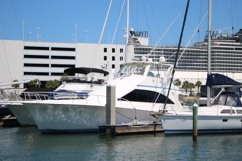 Slide: The Image of 1999 Ocean Yachts model docked in a marina with other boats. - 43