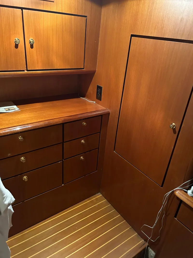 Slide: The Image of 1999 Ocean Yachts interior with wooden cabinets and drawers, showcasing elegant craftsmanship. - 47