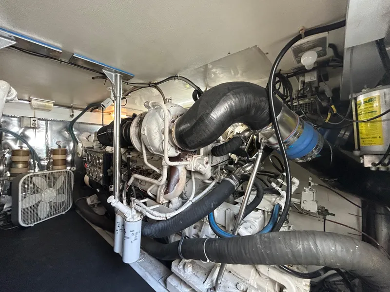 Slide: The Image of Engine room of a 1999 Ocean Yachts model, showcasing complex machinery and piping. - 49