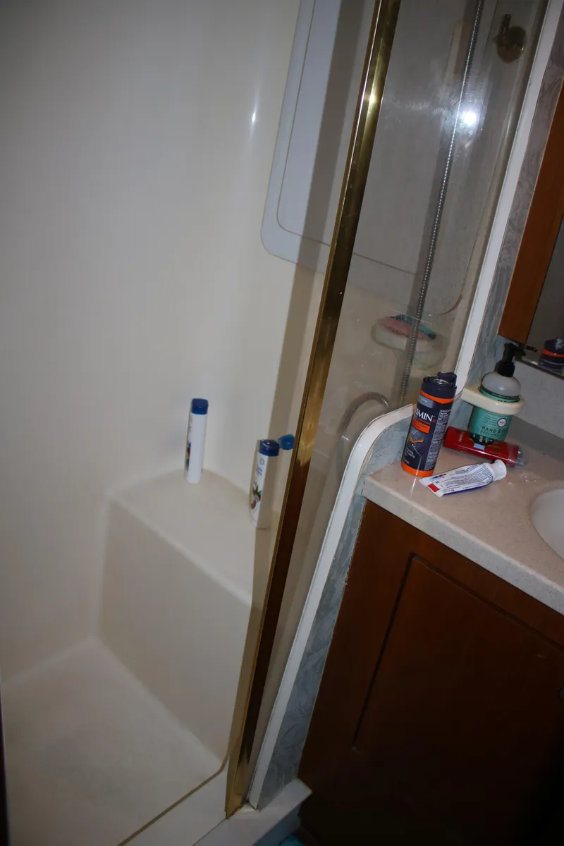 Slide: The Image of Bathroom interior of a 1999 Ocean Yachts model, featuring a shower and sink area. - 6