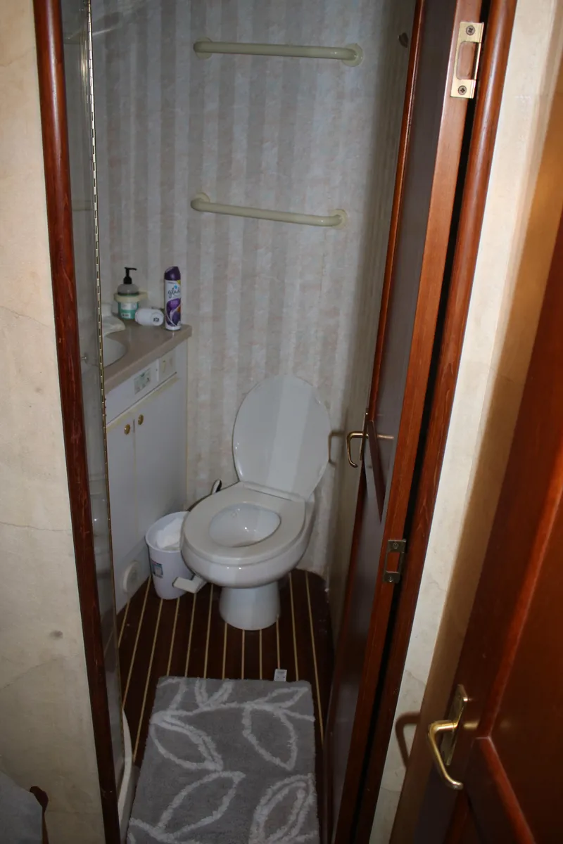 Slide: The Image of Bathroom interior of a 1999 Ocean Yachts model, featuring toilet and sink. - 7