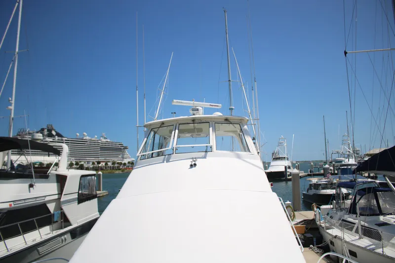 Slide: The Image of 1999 Ocean Yachts model docked in a marina, surrounded by other boats under a clear blue sky. - 16