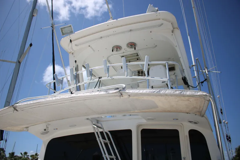 Slide: The Image of 1999 Ocean Yachts model, white yacht exterior with upper deck, clear blue sky background. - 24