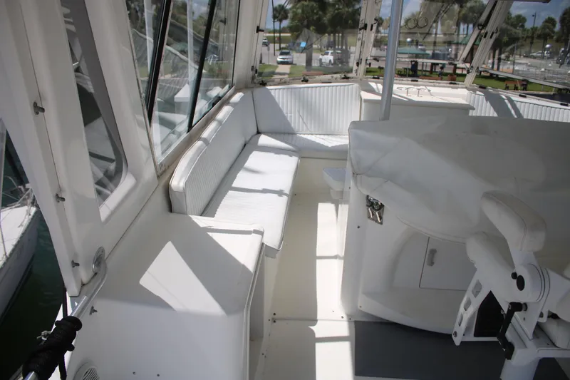 Slide: The Image of 1999 Ocean Yachts model, featuring a spacious white interior with seating and helm. - 28