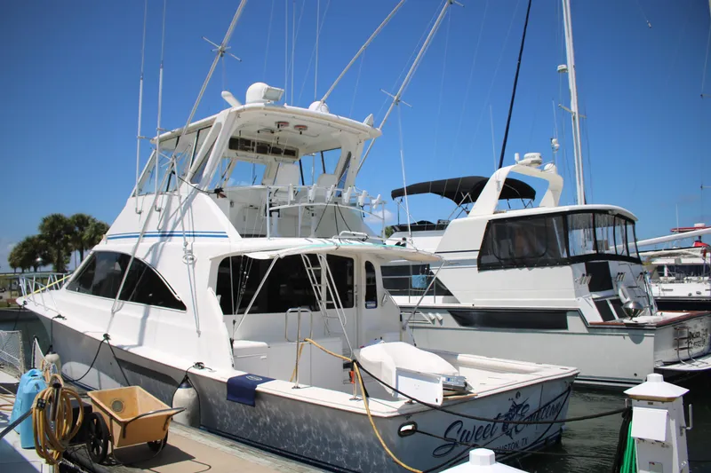 Slide: The Image of 1999 Ocean Yachts model docked at marina under clear blue sky. - 44