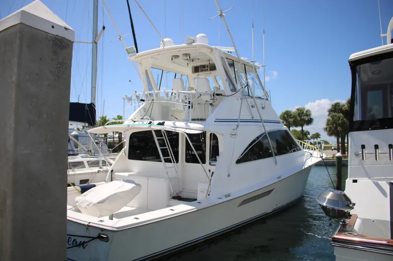 Slide: The Image of 1999 Ocean Yachts model docked at marina under clear blue sky. - 45