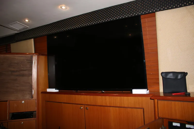Slide: The Image of Interior of a 1999 Ocean Yachts model, featuring a large flat-screen TV. - 8