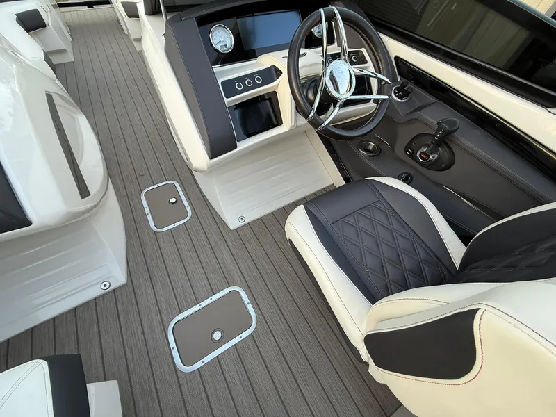 Slide: The Image of 2019 Bennington 25 QX Sport boat interior with sleek steering and modern dashboard design. - 16