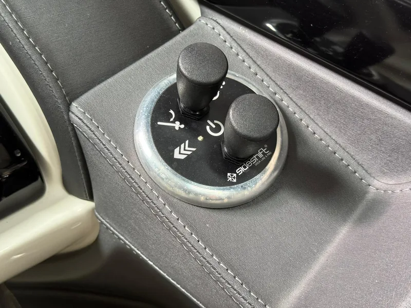 Slide: The Image of Control panel of a 2019 Bennington 25 QX Sport boat with two black knobs. - 17