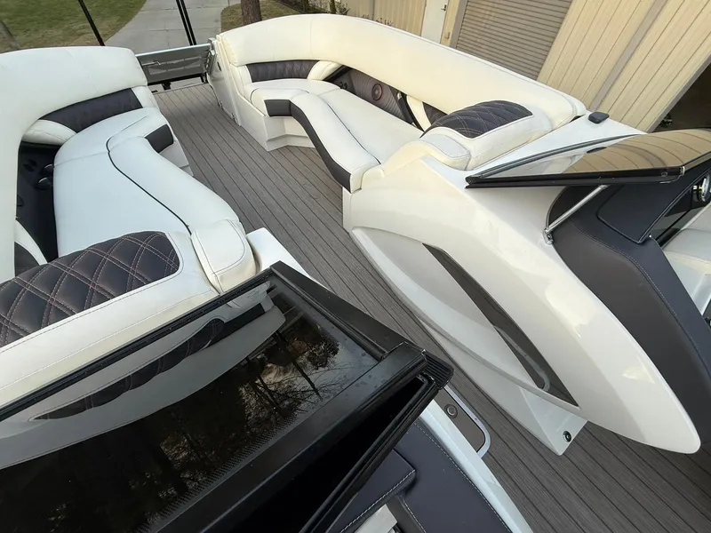 Slide: The Image of 2019 Bennington 25 QX Sport boat interior with luxurious white seating and modern design. - 19