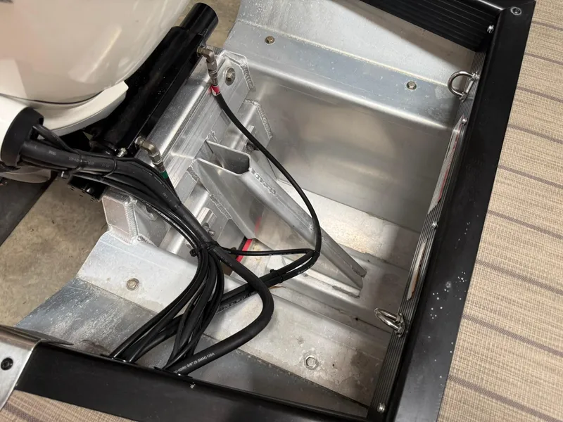 Slide: The Image of 2019 Bennington 25 QX Sport boat engine compartment with wiring and metal components. - 23