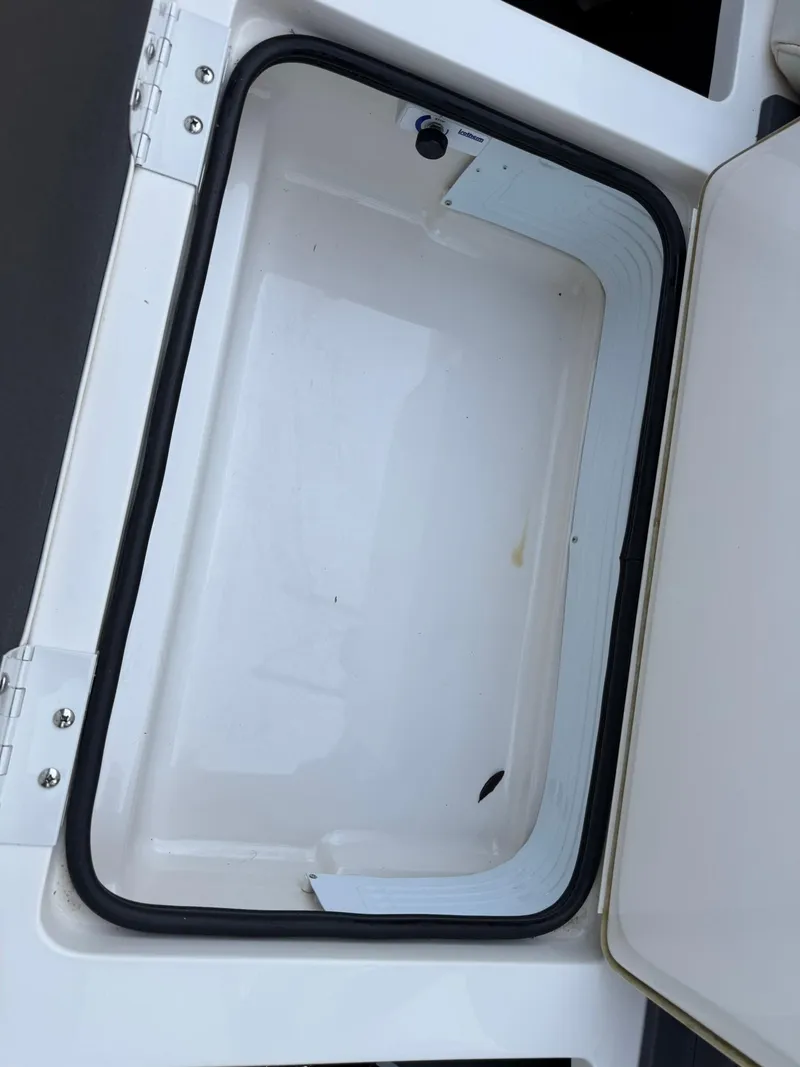Slide: The Image of Storage compartment of 2019 Bennington 25 QX Sport boat, open and empty. - 25