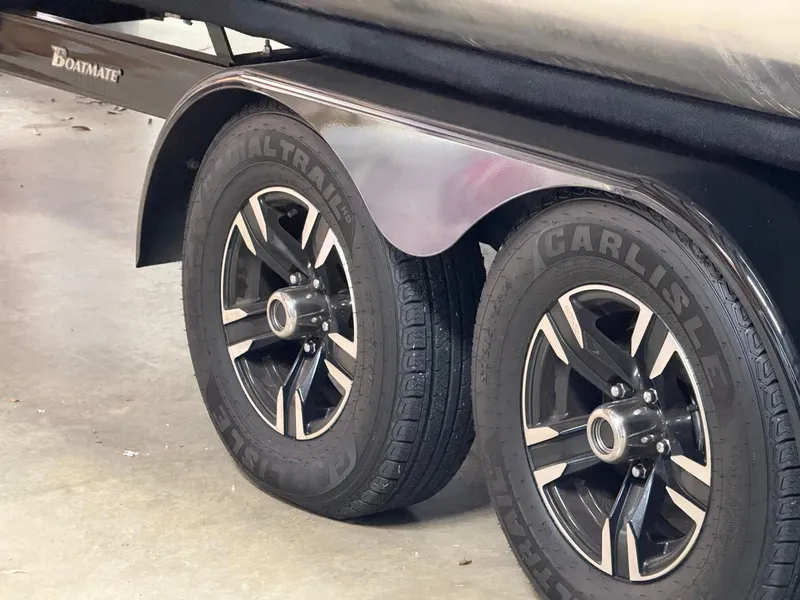 Slide: The Image of Trailer wheels of a 2019 Bennington 25 QX Sport boat, featuring Carlisle tires. - 31