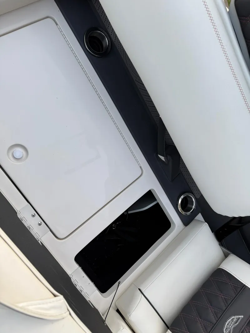 Slide: The Image of 2019 Bennington 25 QX Sport interior with white seating and storage compartments. - 33