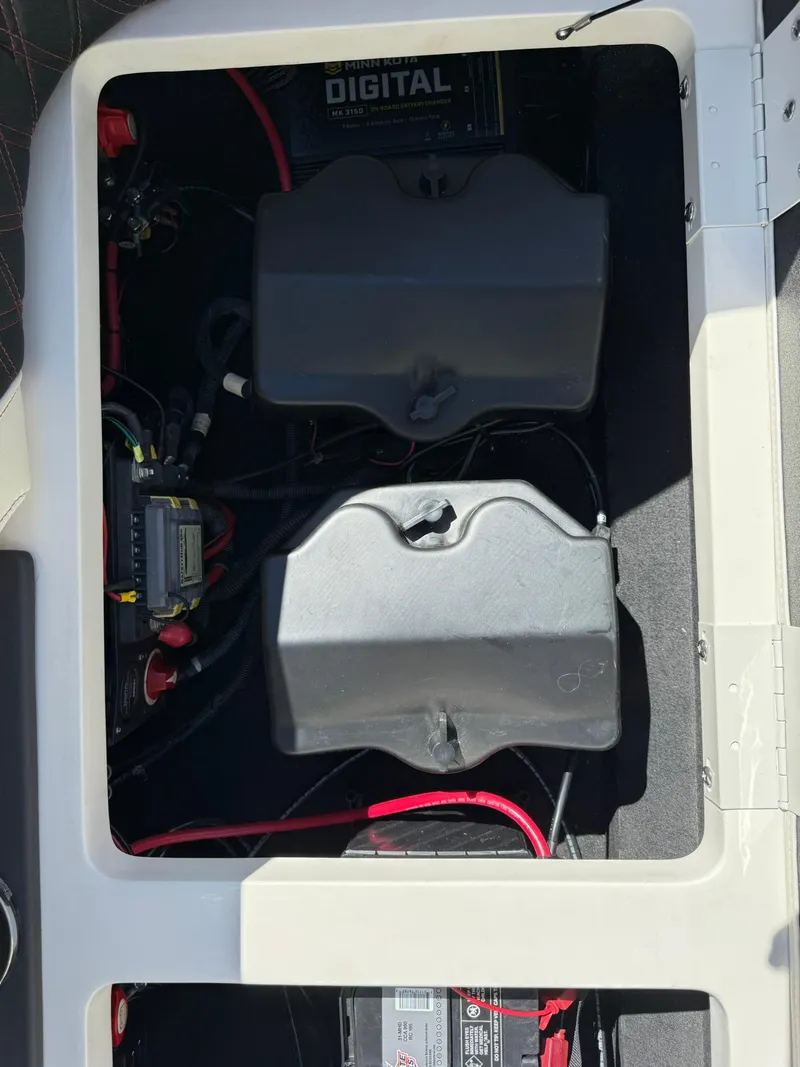 Slide: The Image of 2019 Bennington 25 QX Sport boat battery compartment with wiring and digital components. - 34
