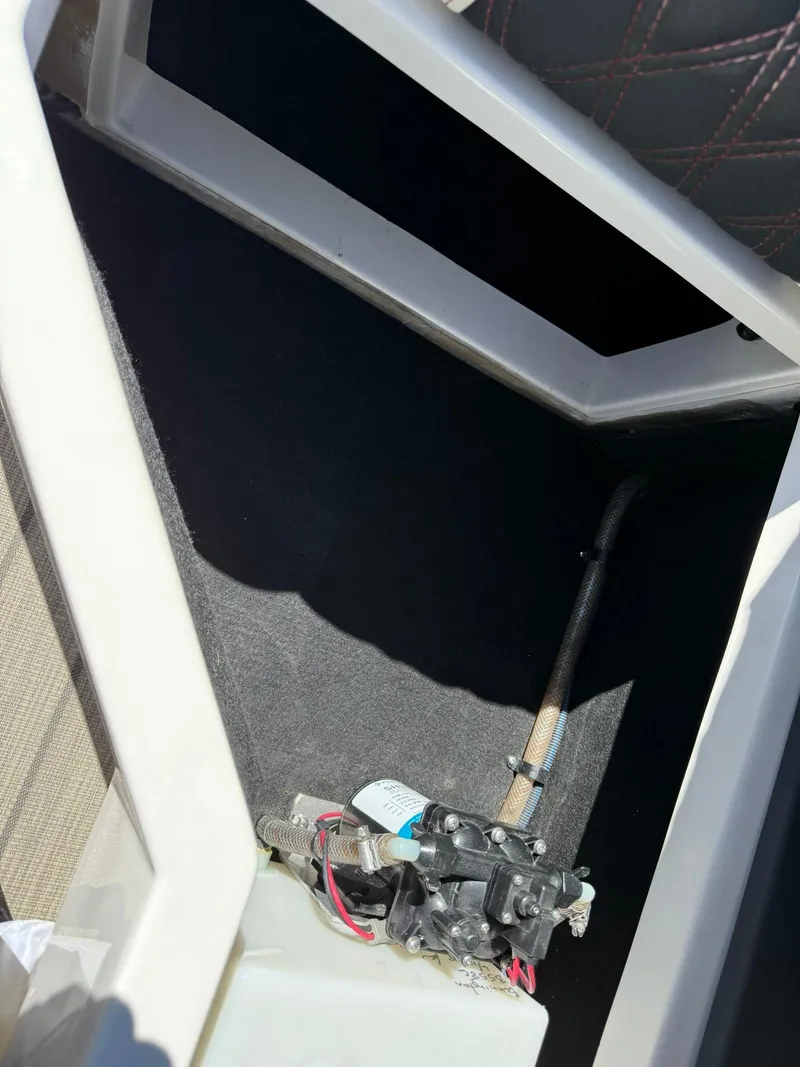 Slide: The Image of 2019 Bennington 25 QX Sport boat interior compartment with wiring and components. - 35