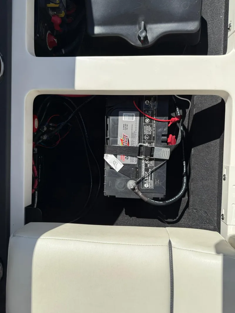 Slide: The Image of 2019 Bennington 25 QX Sport boat battery compartment with visible wiring. - 39