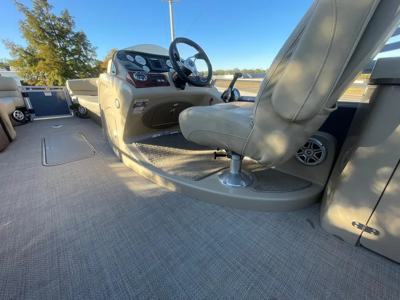 Slide: The Image of 2017 Regency 220 DL3 boat interior with steering wheel and seating, showcasing luxury design. - 10