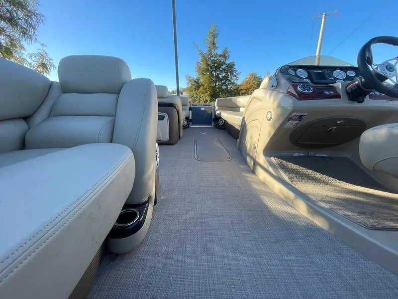 Slide: The Image of Interior of a 2017 Regency 220 DL3 boat with plush seating and modern dashboard. - 16