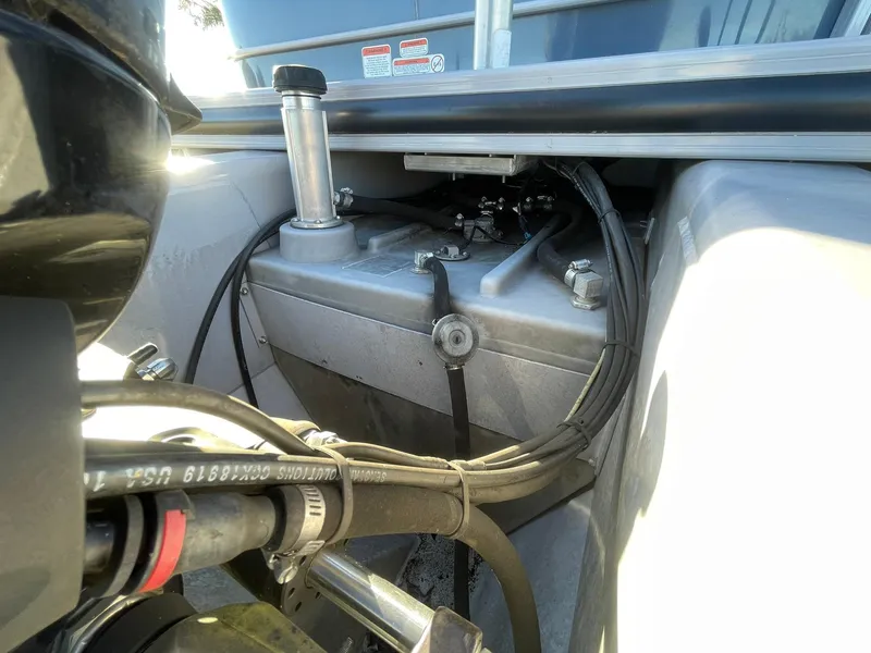Slide: The Image of 2017 Regency 220 DL3 boat engine compartment with visible fuel tank and hoses. - 24
