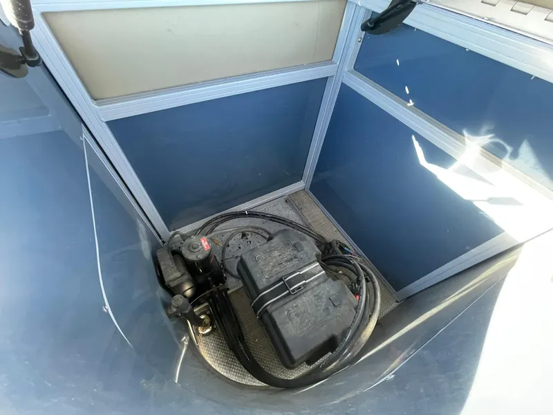 Slide: The Image of Battery compartment of 2017 Regency 220 DL3 boat, featuring cables and secure housing. - 25