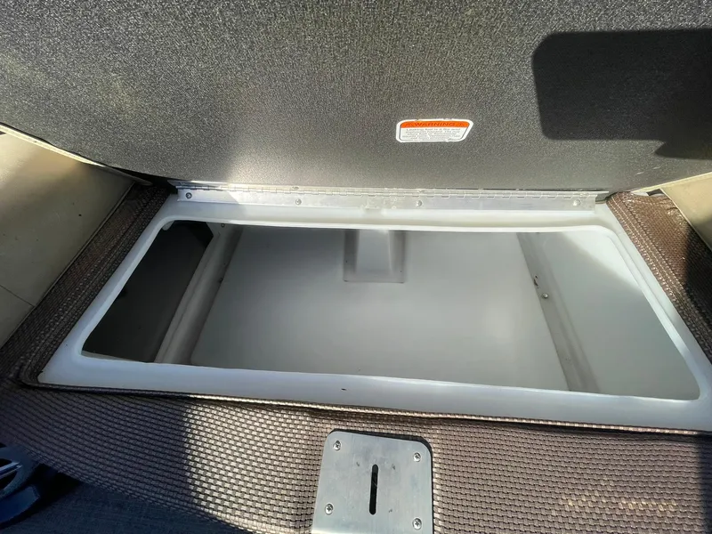 Slide: The Image of Open storage compartment in 2017 Regency 220 DL3 boat, featuring a spacious interior. - 26