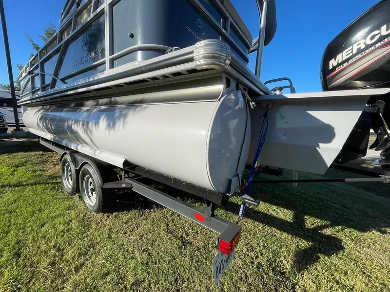 Slide: The Image of 2017 Regency 220 DL3 pontoon boat on trailer, side view, sunny day. - 35