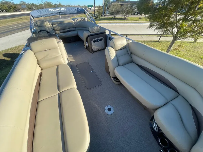 Slide: The Image of 2017 Regency 220 DL3 pontoon boat with spacious seating and elegant interior design. - 5