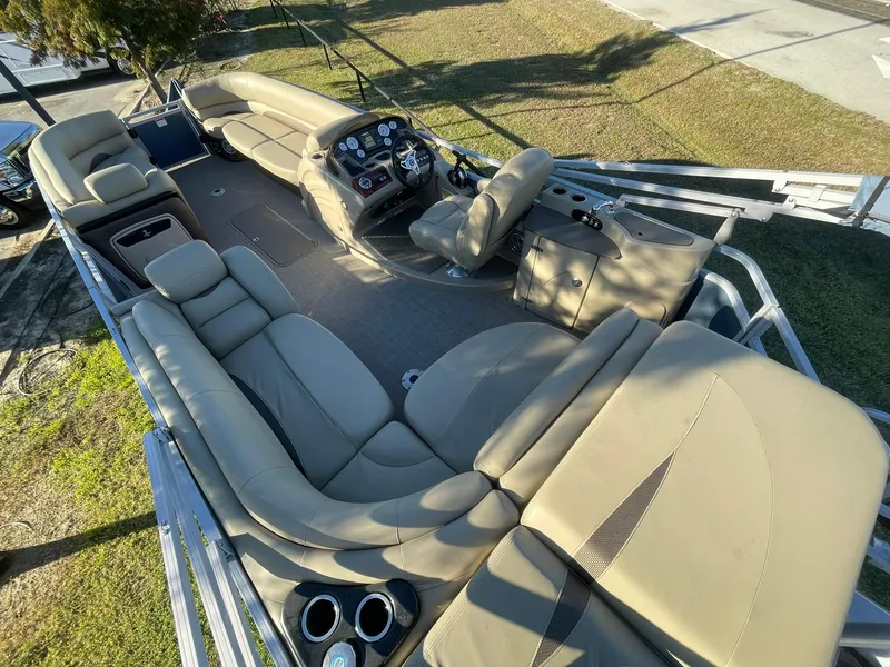 Slide: The Image of 2017 Regency 220 DL3 pontoon boat with spacious seating and modern dashboard. - 6