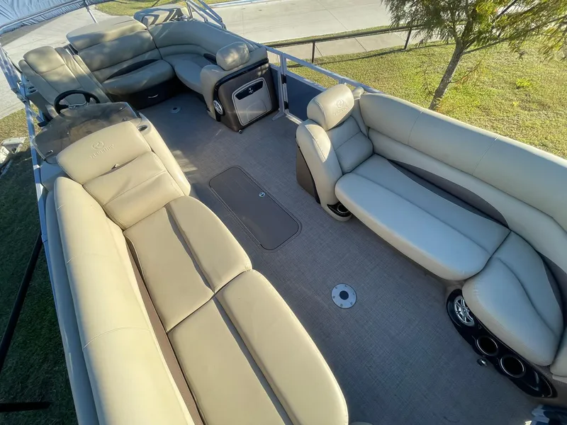Slide: The Image of 2017 Regency 220 DL3 pontoon boat interior with spacious beige seating and modern design. - 7