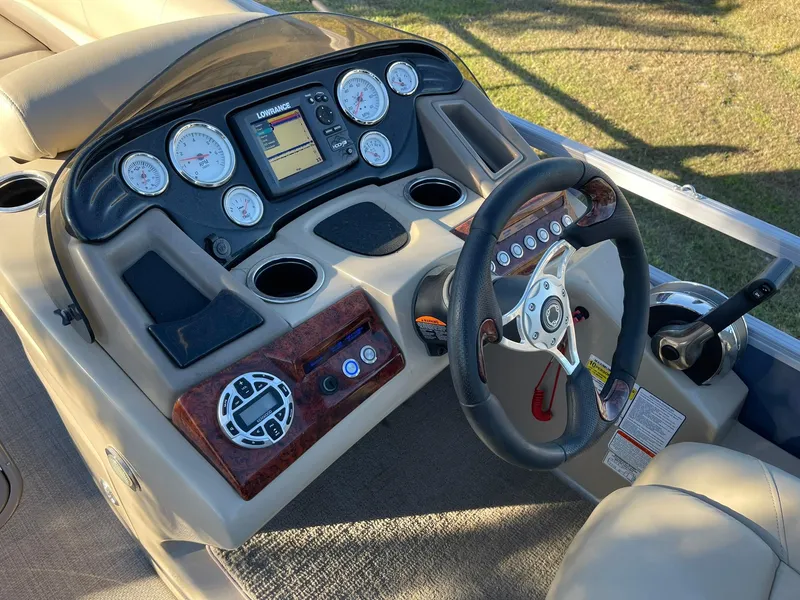 Slide: The Image of 2017 Regency 220 DL3 boat dashboard with steering wheel and control gauges. - 9