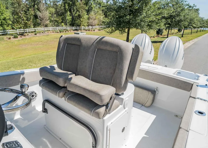 Slide: The Image of 2025 Sea Hunt Gamefish 25 boat interior with cushioned seating and dual outboard motors. - 13