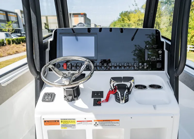 Slide: The Image of 2025 Sea Hunt Gamefish 25 helm with modern controls and navigation display. - 14