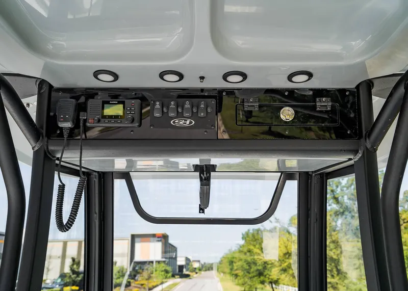 Slide: The Image of 2025 Sea Hunt Gamefish 25 boat console with radio and control panel. - 16