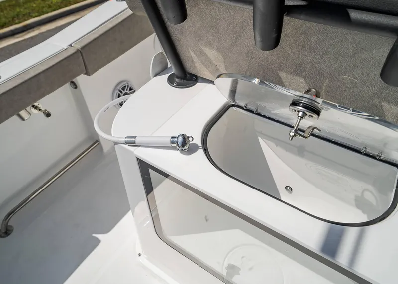 Slide: The Image of 2025 Sea Hunt Gamefish 25 boat interior with livewell and hose attachment. - 19