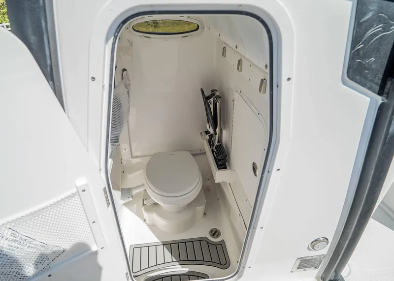 Slide: The Image of Interior of 2025 Sea Hunt Gamefish 25 boat, featuring a compact marine toilet. - 21