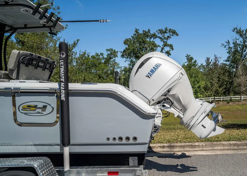 Slide: The Image of 2025 Sea Hunt Gamefish 25 boat with Yamaha outboard motor, parked outdoors. - 3
