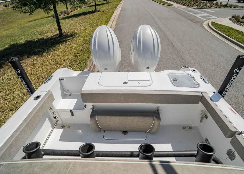 Slide: The Image of 2025 Sea Hunt Gamefish 25 boat interior with dual engines and rod holders. - 5