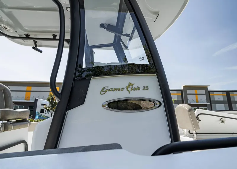 Slide: The Image of 2025 Sea Hunt Gamefish 25 boat, close-up of console and seating area. - 8