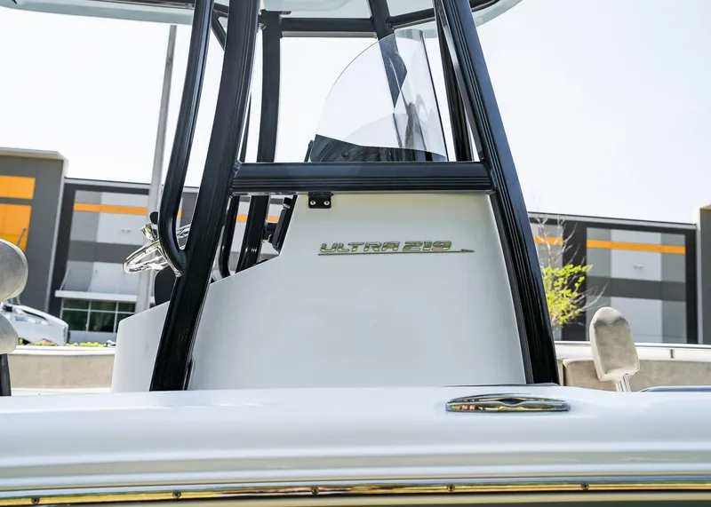 Slide: The Image of 2025 Sea Hunt Ultra 219 boat console with windshield and branding. - 14