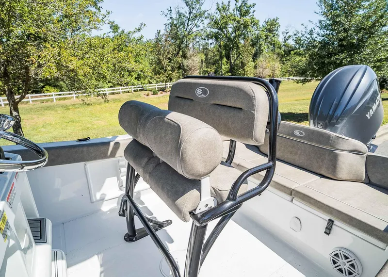 Slide: The Image of 2025 Sea Hunt Ultra 219 boat interior with cushioned seating and Yamaha engine. - 17