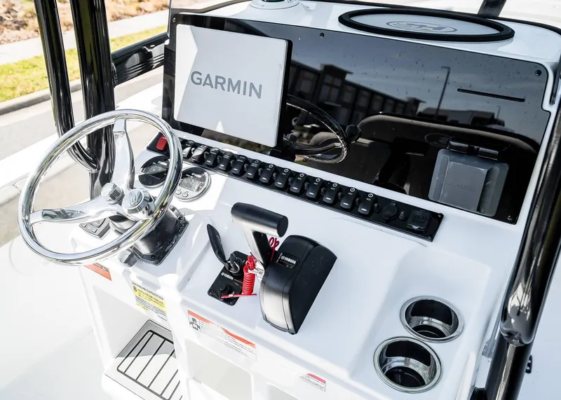 Slide: The Image of 2025 Sea Hunt Ultra 219 boat dashboard with Garmin display and steering wheel. - 22