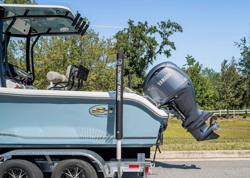 Slide: The Image of 2025 Sea Hunt Ultra 219 boat with Yamaha engine on trailer, parked outdoors. - 3