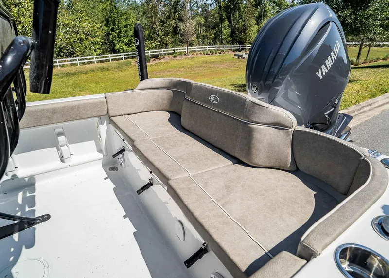 Slide: The Image of 2025 Sea Hunt Ultra 219 boat interior with cushioned seating and Yamaha engine. - 9