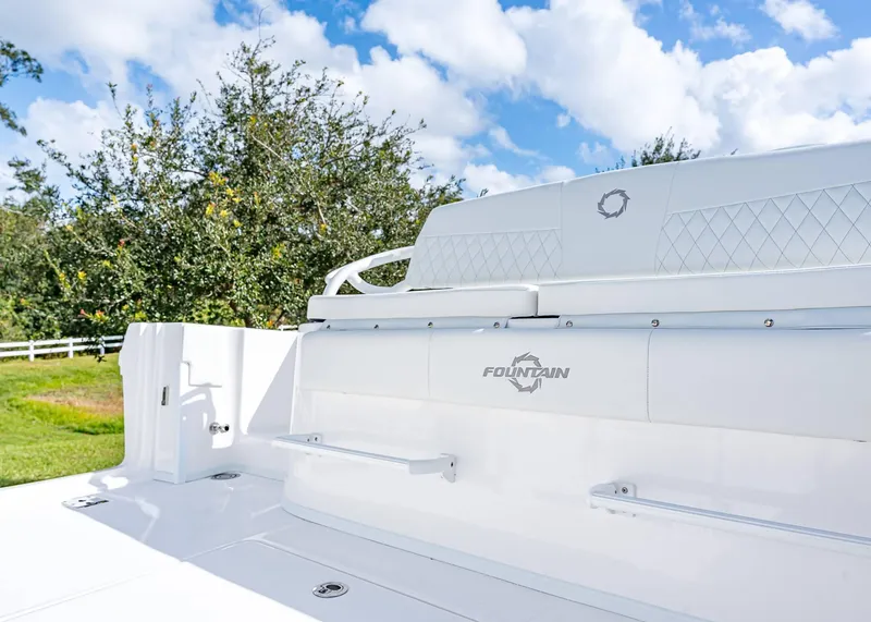 Slide: The Image of 2026 Fountain 38 TE boat with white seating, set against a clear sky and greenery. - 10